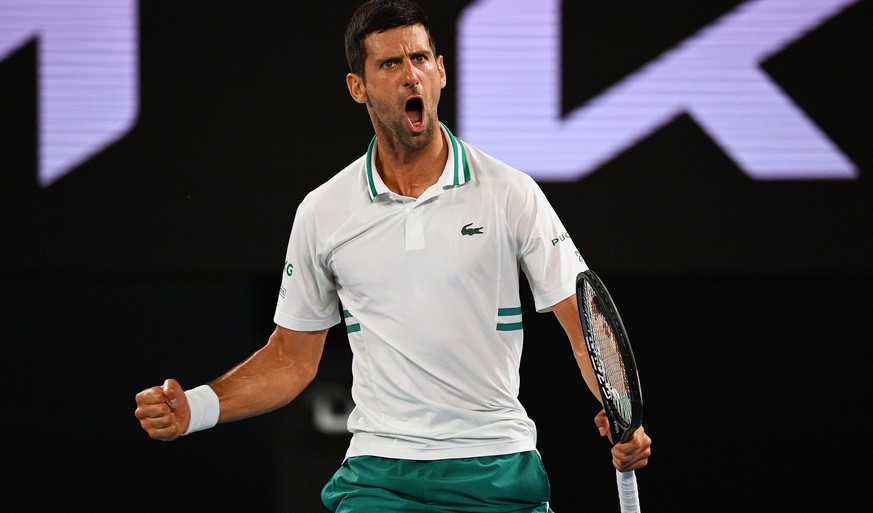 epa09020711 Novak Djokovic of Serbia reacts during his Men&#039;s singles semifinals match against Aslan Karatsev of Russia on Day 11 of the Australian Open at Melbourne Park in Melbourne, 18 February ...