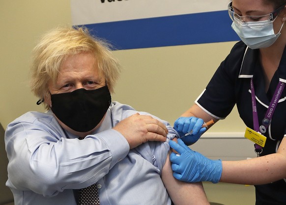Britain&#039;s Prime Minister Boris Johnson receives the first dose of the AstraZeneca vaccine administered by nurse and Clinical Pod Lead, Lily Harrington at St. Thomas&#039; Hospital in London, Frid ...
