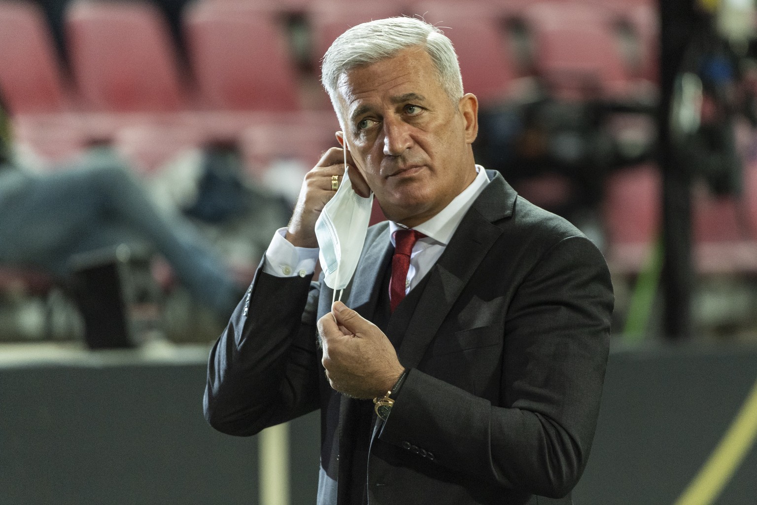 Switzerland&#039;s head coach Vladimir Petkovic takes off his face mask to give a TV interview ahead of the UEFA Nations League group 4 soccer match between Germany and Switzerland at the Rhein Energi ...