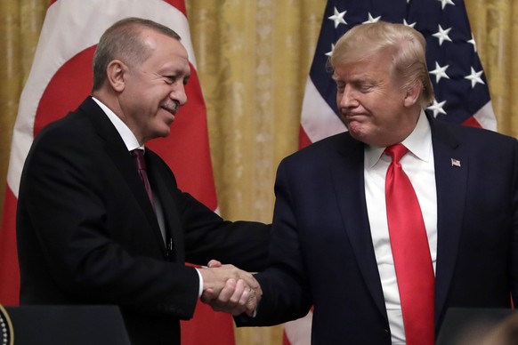 FILE - In this Wednesday, Nov. 13, 2019 file photo, President Donald Trump shakes hands with Turkish President Recep Tayyip Erdogan after a news conference in the East Room of the White House, in Wash ...