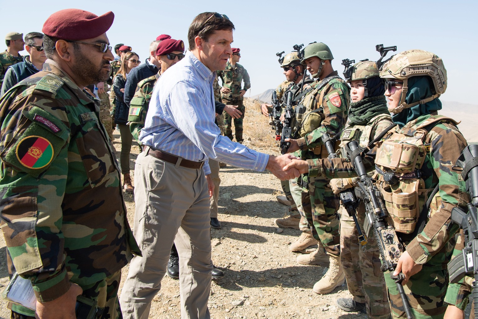 epa07940226 A handout photo made available by the US Department of Defense (DOD) shows US Defense Secretary Mark T. Esper (C) meeting with members of the Afghan special forces to observe their trainin ...