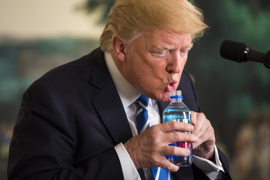 epa08939597 (FILE) US President Donald J. Trump pauses to drink water while touting his foreign policy accomplishments during his trip to Asia in a speech in the Diplomatic Room at the White House in  ...