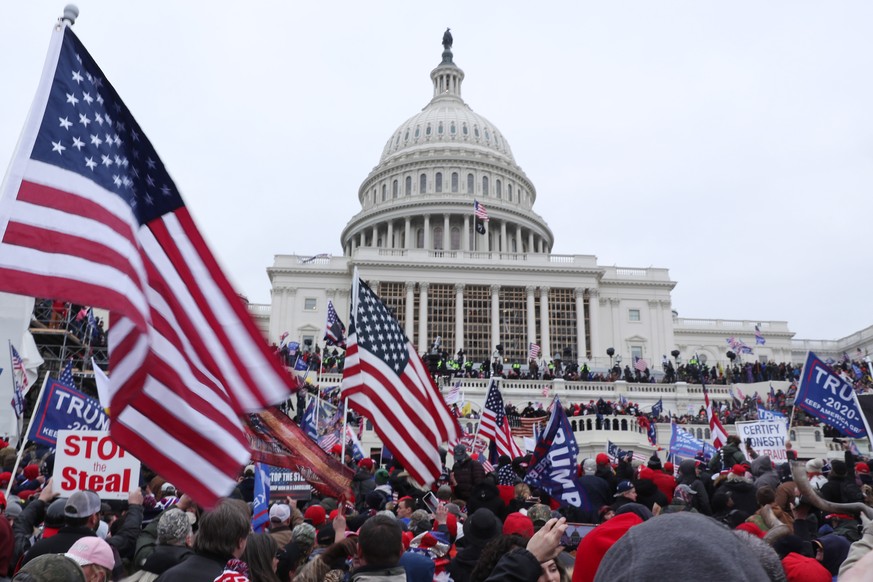 epa08923463 Pro-Trump protesters occupy the grounds of the West Front of the US Capitol, including the inaugural stage and viewing stands, in Washington, DC, USA, 06 January 2021. Protesters stormed t ...
