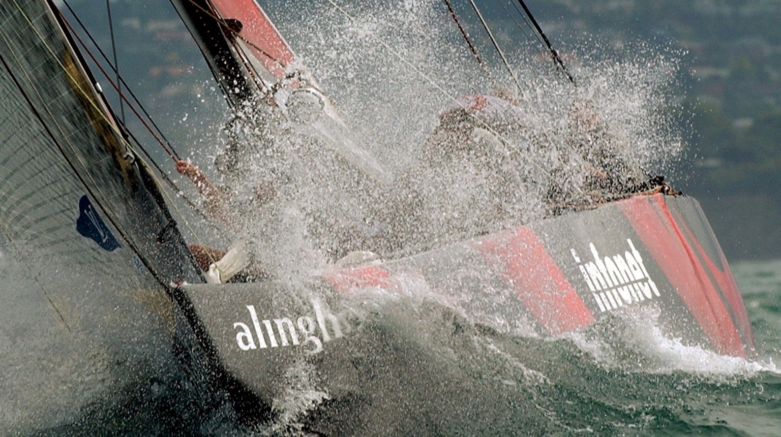 Swiss Defi yacht Alinghi, SUI-64, sailing in a wave during the fifth match-race against the New Zealander defender yacht, Team New Zealand, NZL-82, during the America&#039;s Cup final, in Hauraki gulf ...