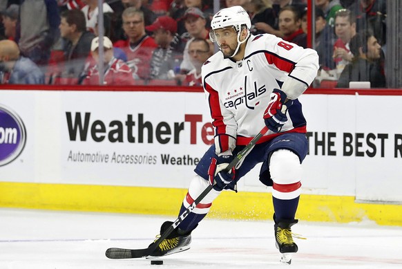 FILE - In this April 18, 2019, file photo, Washington Capitals&#039; Alex Ovechkin (8) works the puck against the Carolina Hurricanes during the first period of Game 4 of an NHL hockey first-round pla ...