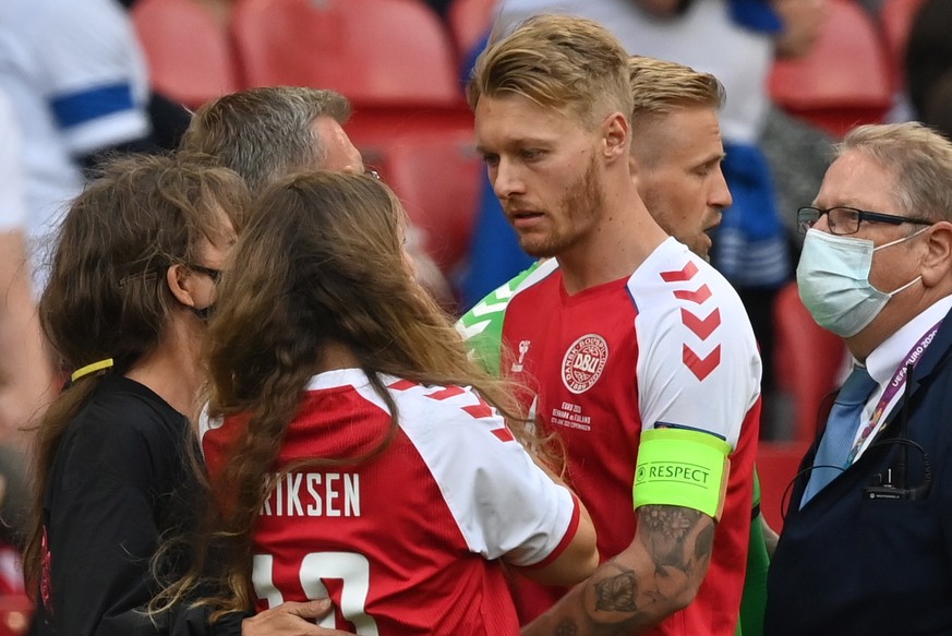 epa09265538 Sabrina Kvist Jensen (2-L), the girlfriend of Denmark&#039;s Christian Eriksen, is being consoled by Denmark&#039;s Simon Kjaer, during the UEFA EURO 2020 group B preliminary round soccer  ...