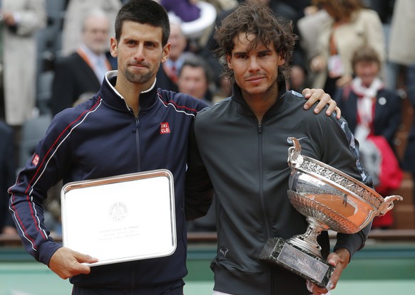 Spain&#039;s Rafael Nadal, right, and Serbia&#039;s Novak Djokovic hold their trophy after their men&#039;s final match in the French Open tennis tournament at the Roland Garros stadium in Paris, Mond ...