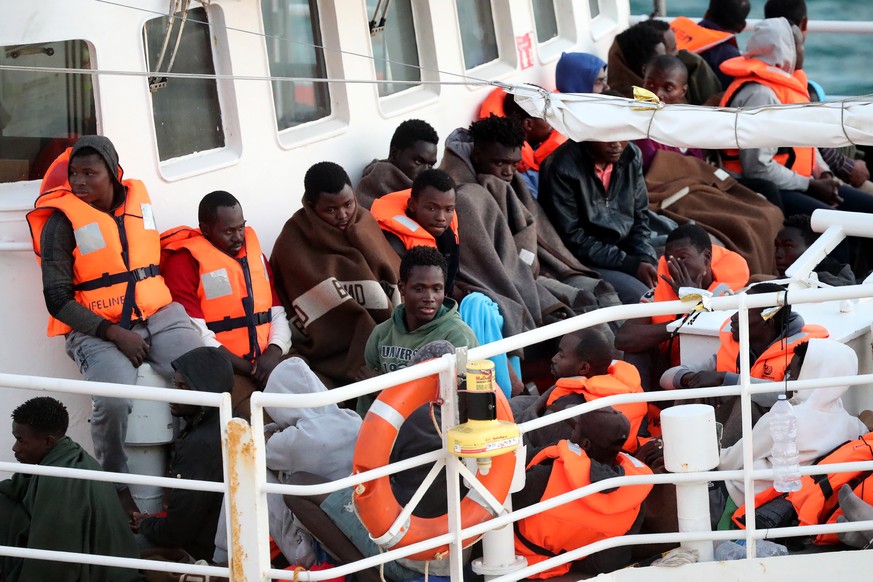 epa06845936 Migrants aboard the Lifeline NGO rescue vessel stranded in the Mediterranean with more than 200 migrants finally berthed in Valletta, Malta, on 27 June 2018. EPA/DOMENIC AQUILINA