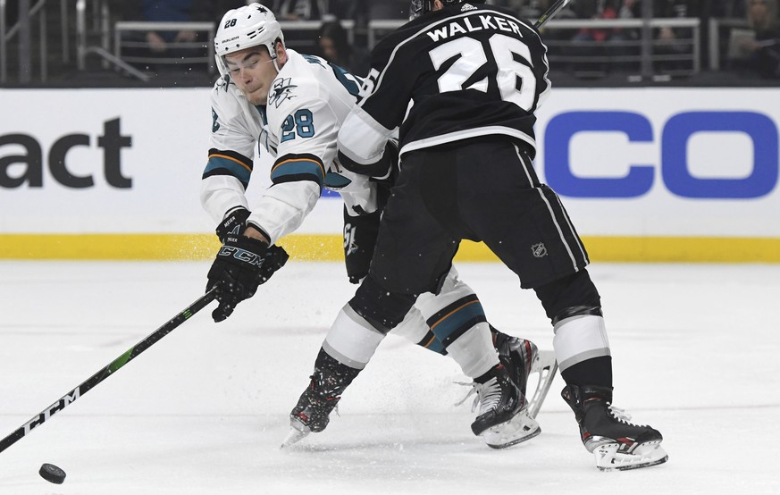 San Jose Sharks right wing Timo Meier, left, is checked by Los Angeles Kings defenseman Sean Walker (26) during the first period of an NHL hockey game, Monday, Nov. 25, 2019, in Los Angeles. (AP Photo ...