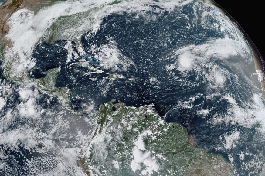 This GOES-16 GeoColor satellite image taken Thursday, Sept. 10, 2020, and provided by NOAA, shows tropical storms forming in the Atlantic. La Nina, which often means a busier Atlantic hurricane season ...