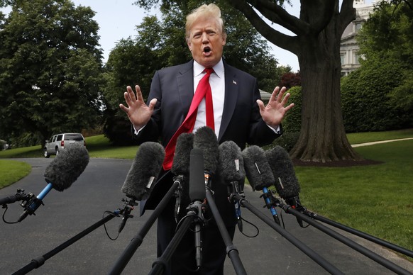 President Donald Trump&#039;s hair is ruffled by a breeze as he speaks to the media on the South Lawn of the White House in Washington, Wednesday, May 23, 2018, en route to a day trip to New York. Tru ...