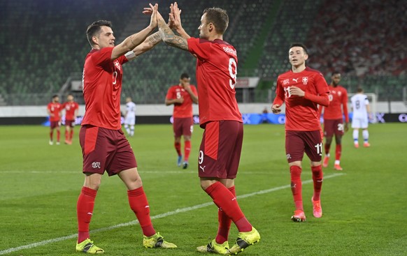 epa09109522 Switzerland&#039;s Haris Seferovic (C) celebrates with teammate Granit Xhaka (L) after scoring the 3-2 lead during the International Friendly soccer match between Switzerland and Finland i ...