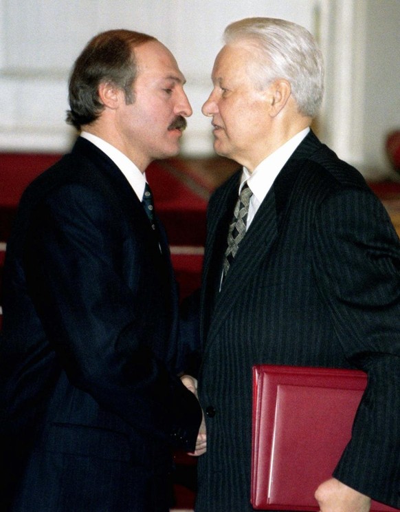 President Boris Yeltsin, right, and Belarusian President Alexander Lukashenko prepare to kiss each other as they shake hands after signing a treaty in Moscow&#039;s Kremlin, Wednesday, April 2, 1997.  ...