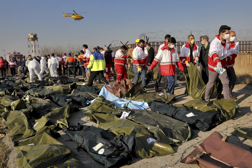 Rescue workers recover bidiesof victims at the scene where a Ukrainian plane crashed in Shahedshahr, southwest of the capital Tehran, Iran, Wednesday, Jan. 8, 2020. A Ukrainian airplane with more than ...
