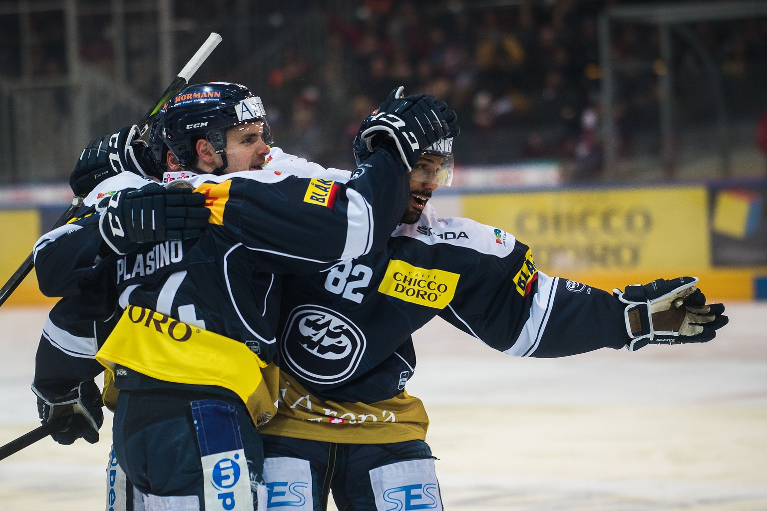 Ambri&#039;s player Nick Plastino left and Ambri&#039;s player Michael Ngoy right celebrate the 4 - 3 goal, during the preliminary round game of National League Swiss Championship 2018/19 between HC A ...