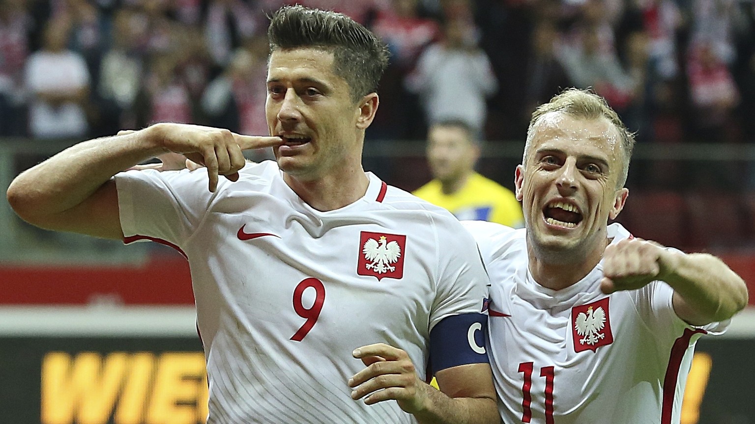 FILE - In this Monday, Sept. 4, 2017 filer, Poland&#039;s Robert Lewandowski,left, celebrates scoring their third goal from the penalty spot with Kamil Grosicki during the World Cup Group E qualifying ...