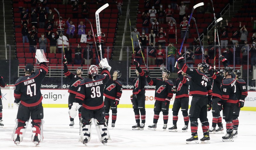 The Carolina Hurricanes salute the fans, who returned to PNC Arena for the first time this season, after a win over the Detroit Red Wings in an NHL hockey game in Raleigh, N.C., Thursday, March 4, 202 ...