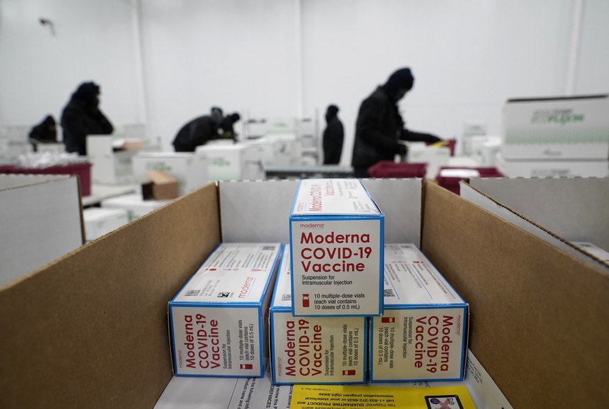 FILE - In this Dec. 20, 2020, file photo, boxes containing the Moderna COVID-19 vaccine are prepared to be shipped at the McKesson distribution center in Olive Branch, Miss. .Efforts to vaccinate Amer ...