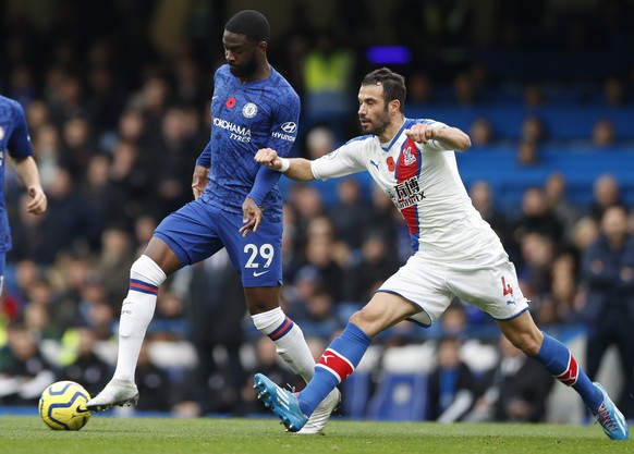 FILE - In this Saturday, Nov. 9, 2019 filer, Crystal Palace&#039;s Luka Milivojevic, right, challenges Chelsea&#039;s Fikayo Tomori during their English Premier League soccer match between Chelsea and ...