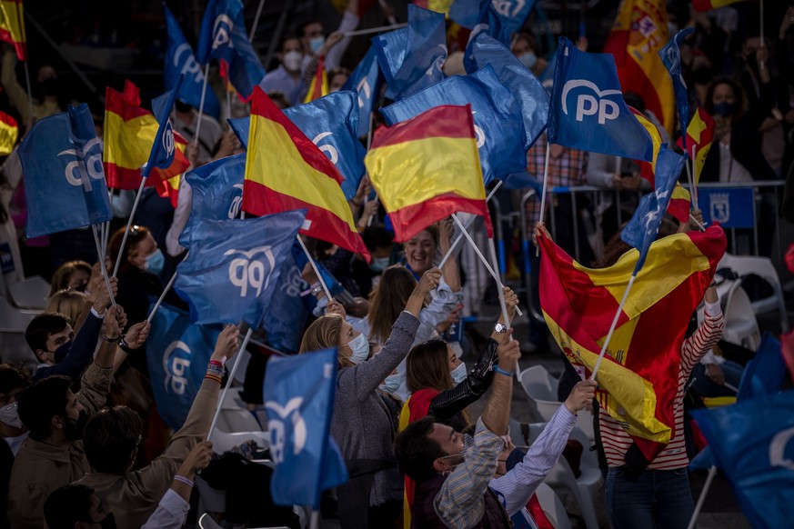 Supporters of conservative Madrid president Isabel Diaz Ayuso wave flags outside the popular party headquarters in Madrid, Spain, Tuesday, May 4, 2021. Over 5 million Madrid residents have voted for a ...