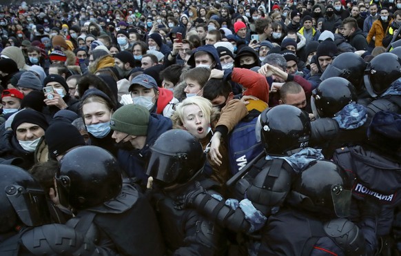 FILE - In this Jan. 23, 2021, file photo, people clash with police during a protest against the jailing of opposition leader Alexei Navalny in St. Petersburg, Russia. Allies of Navalny are calling for ...