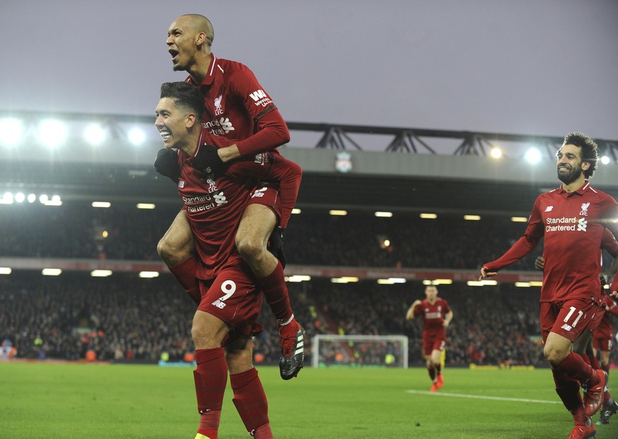 Liverpool&#039;s Roberto Firmino, left, celebrates with his teammate Liverpool&#039;s Fabinho, top, and Liverpool&#039;s Mohamed Salah, right, after scoring his side&#039;s second goal during the Engl ...