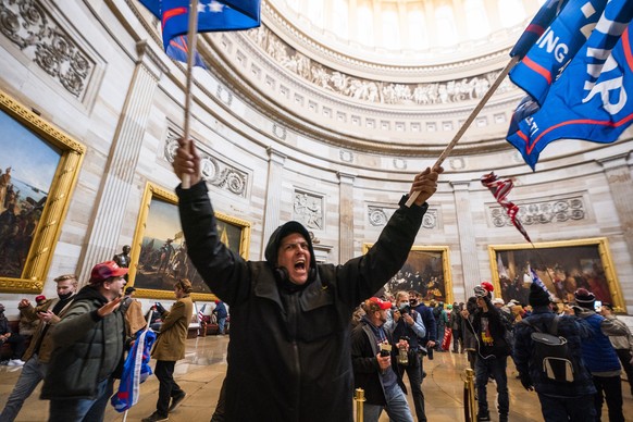 epaselect epa08923451 Supporters of US President Donald J. Trump in the Capitol Rotunda after breaching Capitol security in Washington, DC, USA, 06 January 2021. Protesters entered the US Capitol wher ...