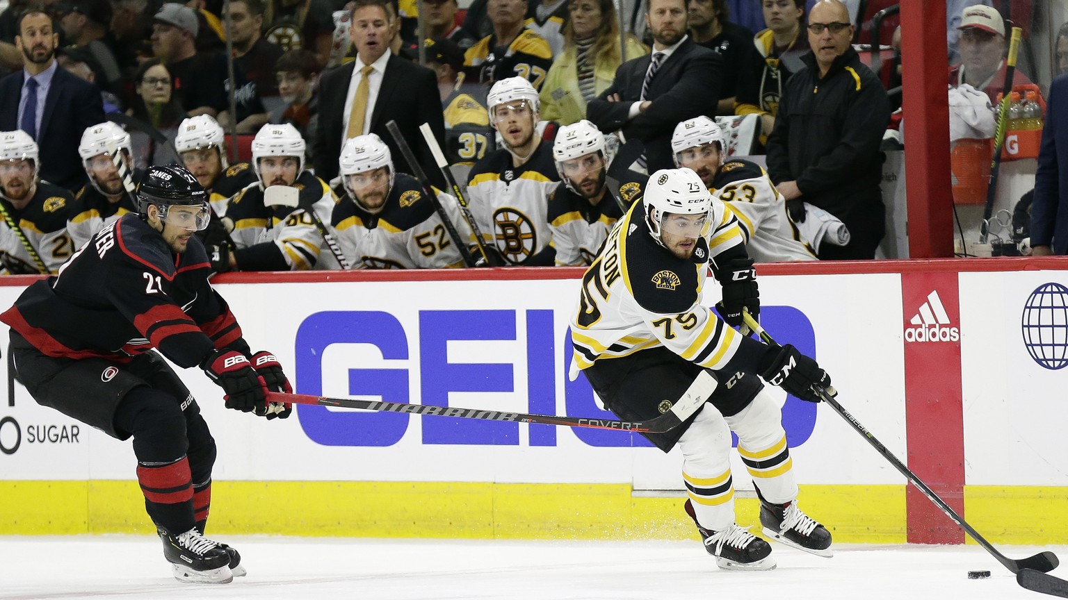 Boston Bruins&#039; Connor Clifton controls the puck while Carolina Hurricanes&#039; Nino Niederreiter (21), of Switzerland, defends during the first period in Game 3 of the NHL hockey Stanley Cup Eas ...