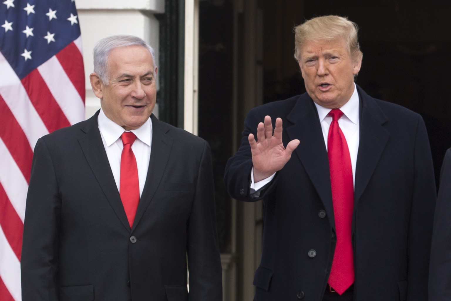 epa07462905 US President Donald J. Trump (R) waves beside Prime Minister of Israel Benjamin Netanyahu (L) while greeting him at the South Portico of the White House in Washington, DC, USA, 25 March 20 ...