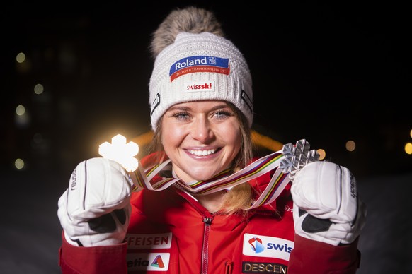Corinne Suter of Switzerland poses with the Gold medal for Downhill race Silver medal for Super-G race front of the hotel of the Swiss team after the women&#039;s Downhill race at the 2021 FIS Alpine  ...