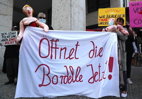 epa08524329 People working in the sex industry hold a banner reading &#039;Open the Brothels Now!&#039; stage a protest rally near the German Federal Council building in Berlin, Germany, 03 July 2020. ...
