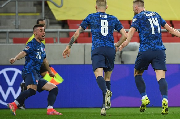 Slovakia&#039;s players Robert Mak, left, and Ondrej Duda, centre, celebrate after Slovakia&#039;s Milan Skriniar, right, scored the opening goal during the World Cup 2022 group H qualifying soccer ma ...