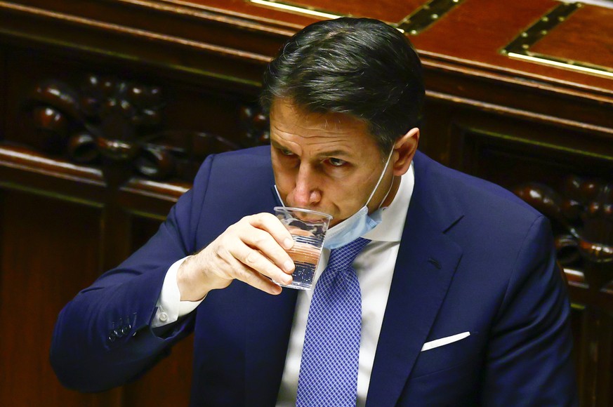 Premier Giuseppe Conte drinks water at the lower chamber of Parliament, in Rome, Monday, Jan. 18, 2021. Conte fights for his political life with an address aimed at shoring up support for his governme ...