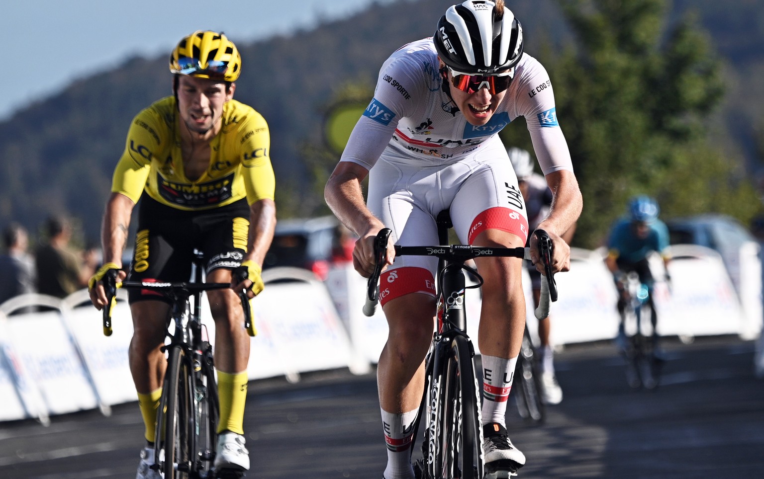 epa08666812 Slovenian rider Tadej Pogacar (R) of the UAE-Team Emirates crosses the finish line to win the 15th stage of the Tour de France over 174.5km from Lyon to Grand Colombier, France, 13 Septemb ...