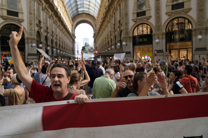 People stage a protest against the &quot;green pass&quot; in Milan, Italy, Saturday, July 24, 2021. Italy&#039;s government approved a decree ordering the use of the so-called &quot;green&quot; passes ...
