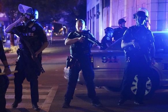 Police stand at an intersection after an officer was shot, Wednesday, Sept. 23, 2020, in Louisville, Ky. A grand jury has indicted one officer on criminal charges six months after Breonna Taylor was f ...
