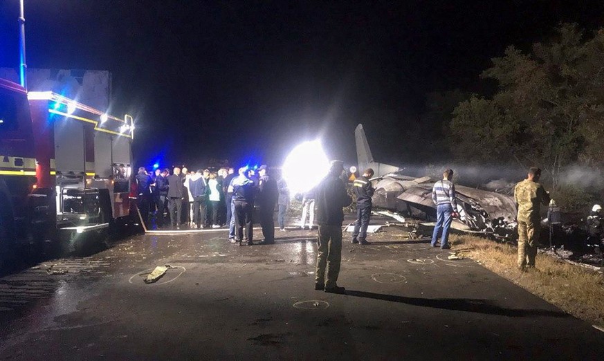 epa08697924 A handout photo made available by the State Emergency Service of Ukraine press service shows the crash site of the An-26 plane near Chuhuiv (Chuguev), Kharkiv region, eastern Ukraine, late ...