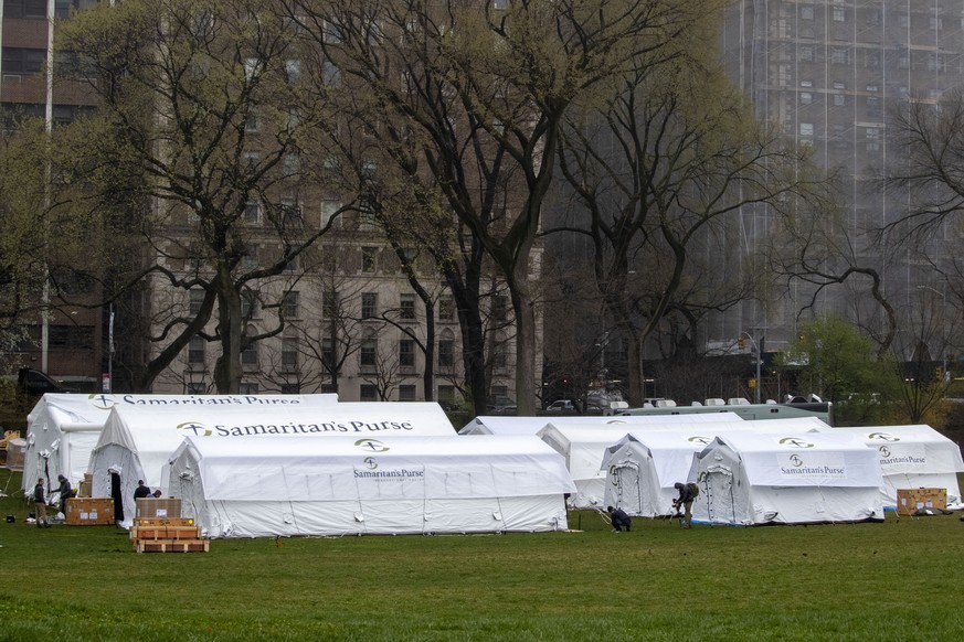 A Samaritan&#039;s Purse crew works on building a 68 bed emergency field hospital specially equipped with a respiratory unit in New York&#039;s Central Park across from The Mount Sinai Hospital, Sunda ...