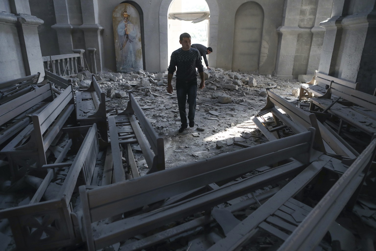 A man walks in rubbles of the Ghazanchetsots (Holy Saviour) Cathedral in the city of Shusha, some 15 kilometers from the Nagorno-Karabakh province&#039;s capital Stepanakert, Thursday, Oct. 8, 2020, a ...