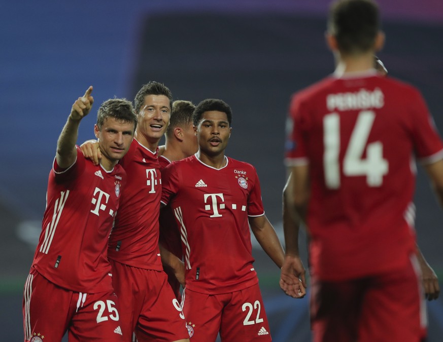 Bayern&#039;s Serge Gnabry, right, celebrates his side&#039;s second goal with teammates Robert Lewandowski, center, and Thomas Mueller during the Champions League semifinal soccer match between Lyon  ...