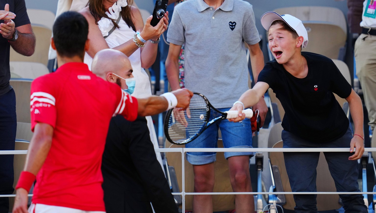 Mandatory Credit: Photo by Javier Garcia/BPI/Shutterstock 12058233md Novak Djokovic hands his racquet to an excited young fan after winning the Men s Singles final French Open Tennis, Day Fifteen, Rol ...