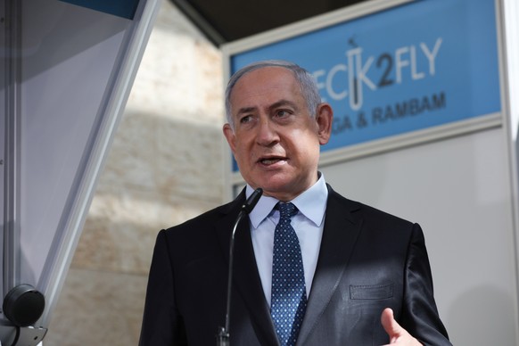 epa08809602 Israeli Prime Minister Benjamin Netanyahu speaks as he visits the new coronavirus lab test center at Ben-Gurion International Airport, near Tel Aviv, Israel, 09 November 2020. EPA/OHAD ZWI ...