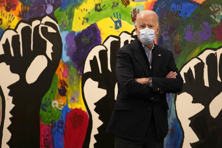 Democratic presidential candidate former Vice President Joe Biden pauses in front of a mural during visit to The Warehouse teen center in Wilmington, Del., Tuesday, Nov. 3, 2020. (AP Photo/Carolyn Kas ...