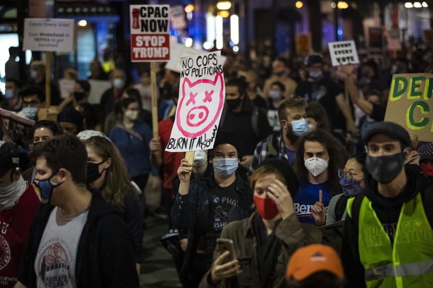 Protesters march through the Loop to demand every vote be counted in the general election, Wednesday night, Nov. 4, 2020, in Chicago. (Ashlee Rezin Garcia/Chicago Sun-Times via AP)