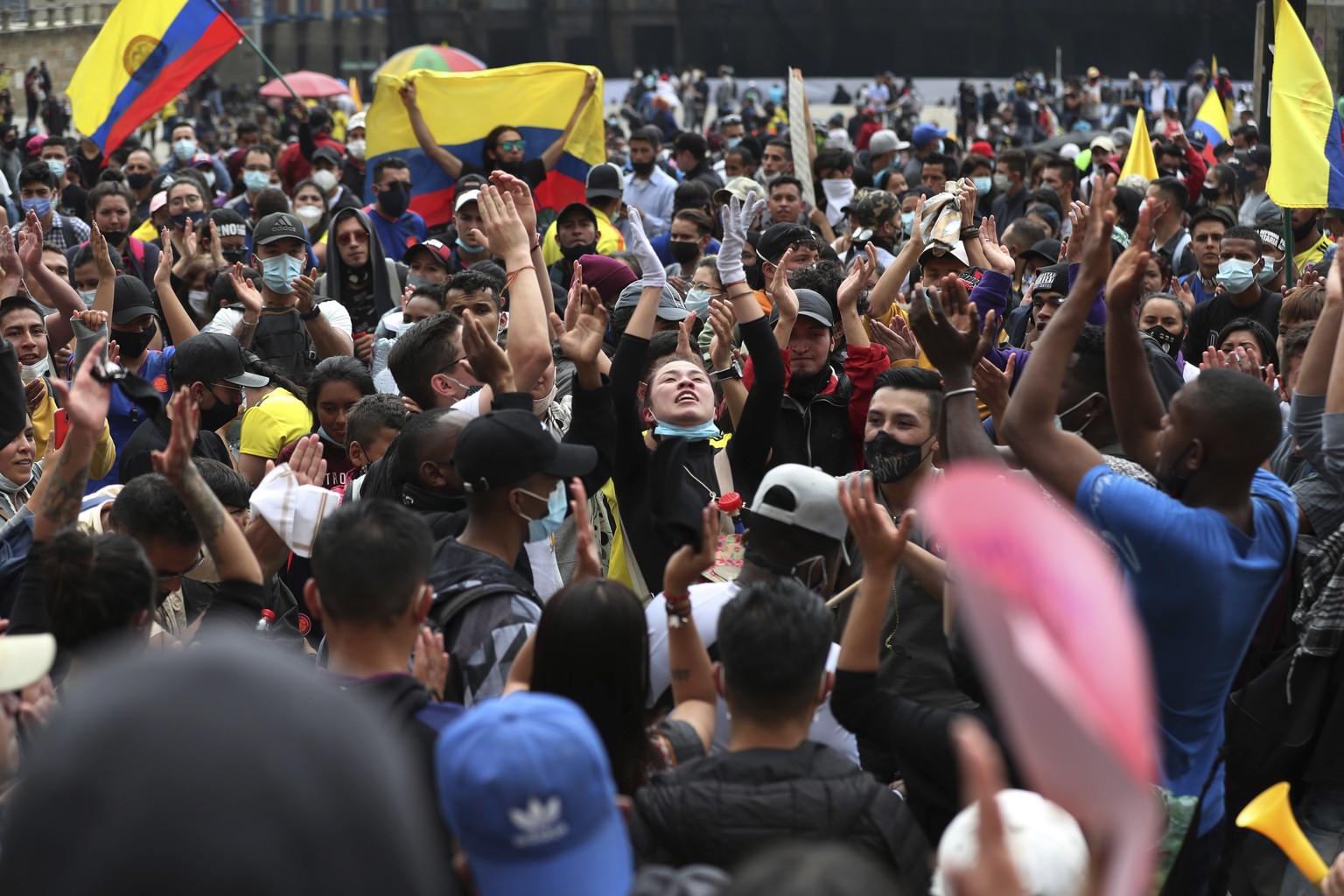 People shout slogans during a demonstration against government-proposed tax reform, marking May Day, or International Workers&#039; Day, gathered in Bolivar Square in Bogota, Colombia, Saturday, May 1 ...