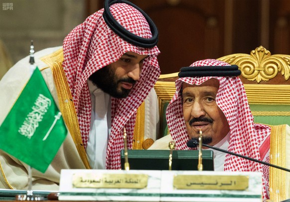 FILE - In this Dec. 9, 2018 file photo, released by the state-run Saudi Press Agency, Saudi Crown Prince Mohammed bin Salman, left, speaks to his father, King Salman, at a meeting of the Gulf Cooperat ...