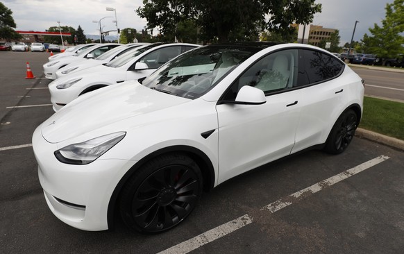 FILE - In this Sunday, June 28, 2020 file photo, 2020 Model Y electric sports-utility vehicles sit in the parking lot of a Tesla store in Littleton, Colo. Tesla overcame a seven-week pandemic-related  ...