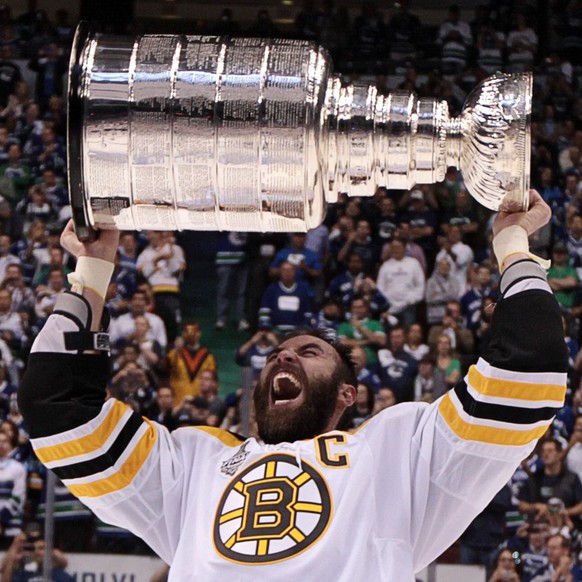 Boston Bruins&#039; Zdeno Chara, of Slovakia, hoists the cup following his team&#039;s 4-0 win over the Vancouver Canucks in Game 7 of the NHL hockey Stanley Cup Finals on Wednesday, June 15, 2011, in ...