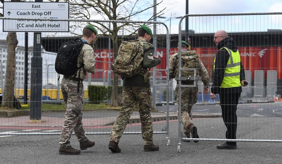 epa08338935 Military personnel outside the Nightingale Hospital at the ExCel conference center in London, Britain, 02 April 2020. The temporary hospital is suppose to be ready to take care of coronavi ...
