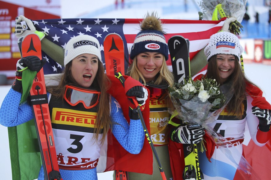United States&#039; Mikaela Shiffrin, center, winner of the women&#039;s super G, celebrates with second-placed Italy&#039;s Sofia Goggia, left, and third-placed Switzerland&#039;s Corinne Suter, at t ...